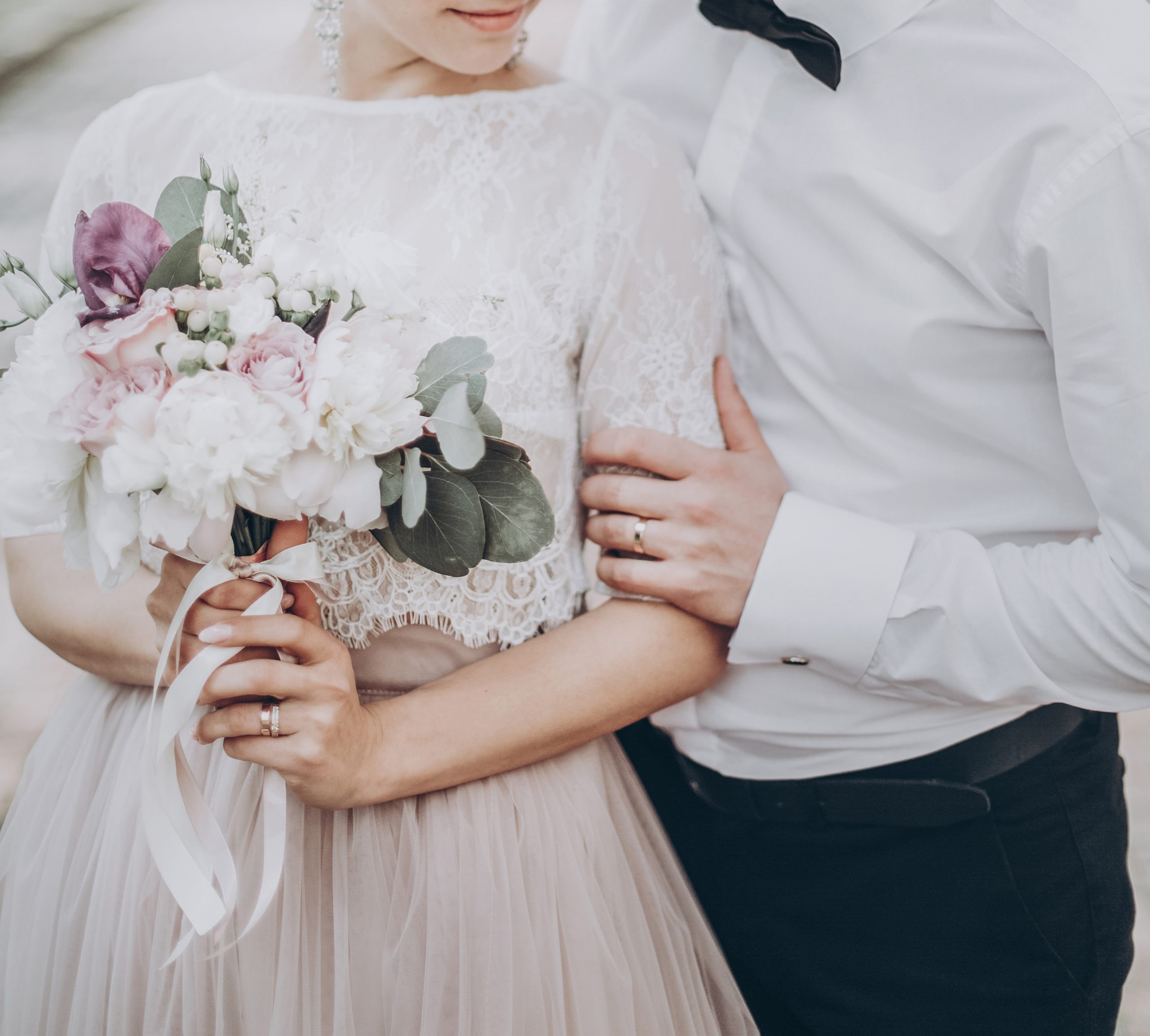 stylish wedding couple with bouquet